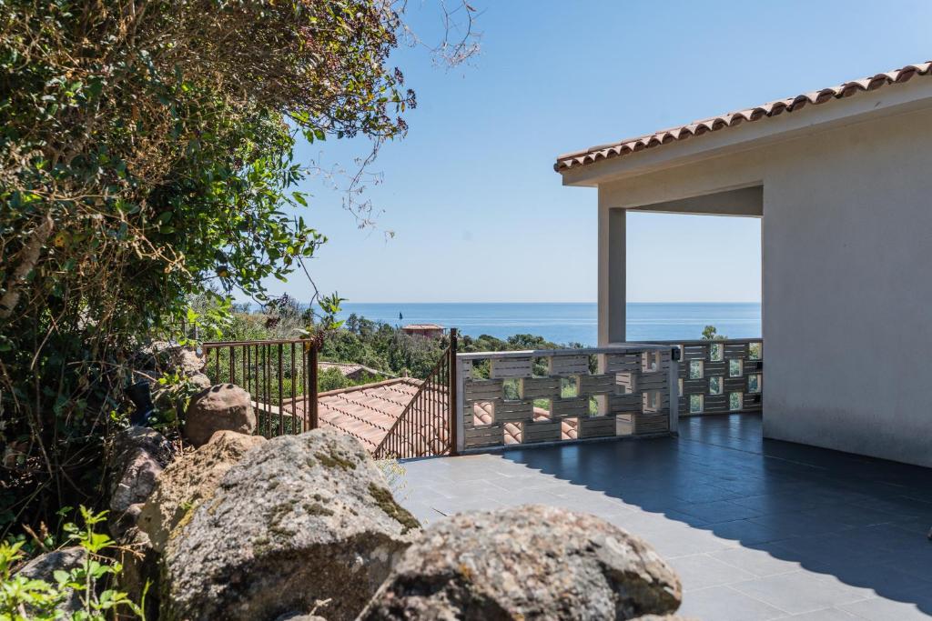 a view of the ocean from the balcony of a house at Appartement Mare è Machja vue mer in Sari Solenzara