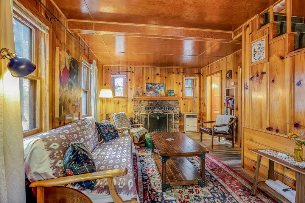 a living room with a couch and a table at Walden in the Woods in Idyllwild
