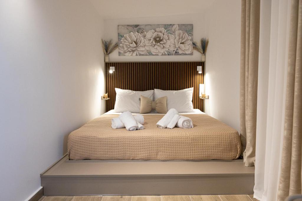 a bedroom with a bed with two towels on it at Εlysian III in Mavrovouni