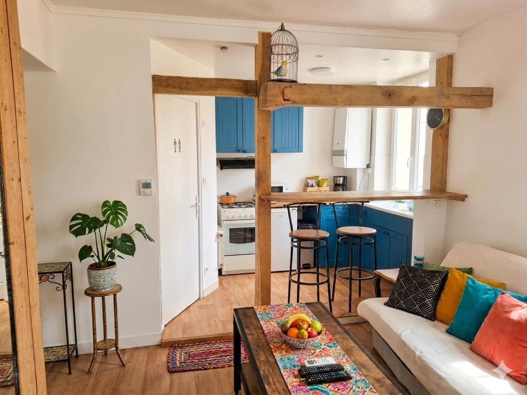 a living room with a couch and a table at La Plage in Fécamp
