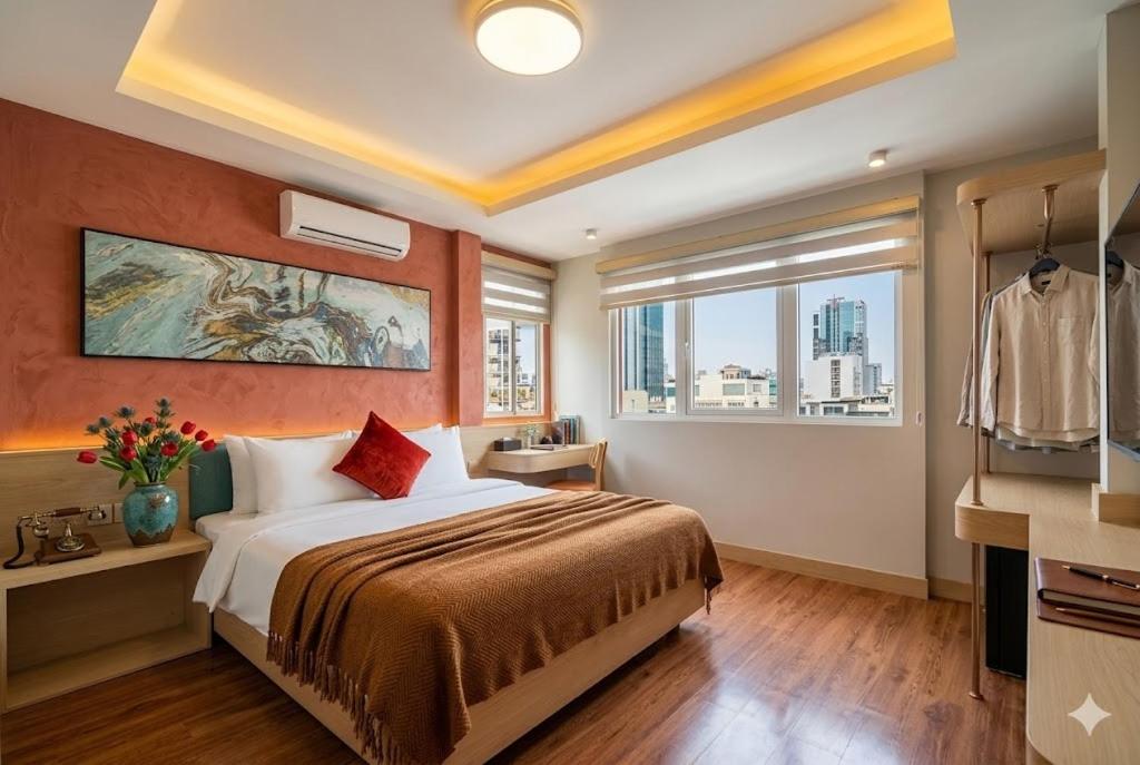 a hotel room with a bed and a window at Vibe Hotel Managed By Nicecy in Ho Chi Minh City
