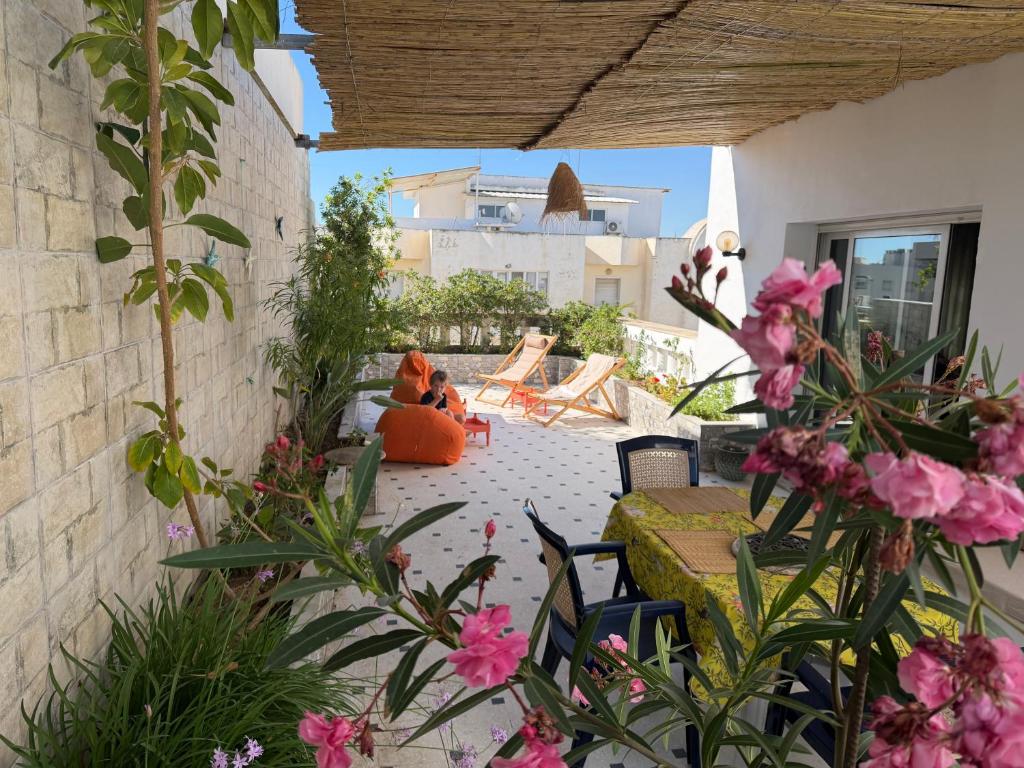 two teddy bears sitting on a patio with flowers at Casaflor Tunis in Tunis