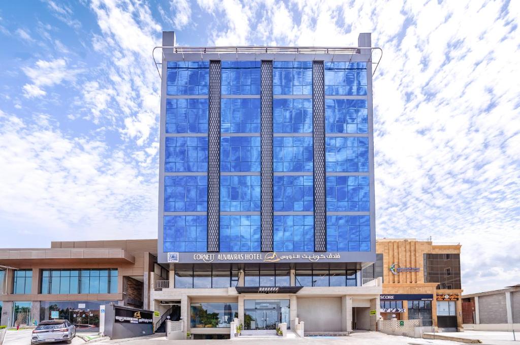 a tall building with a lot of glass windows at فندق كورنيت النورس - جدة in Jeddah