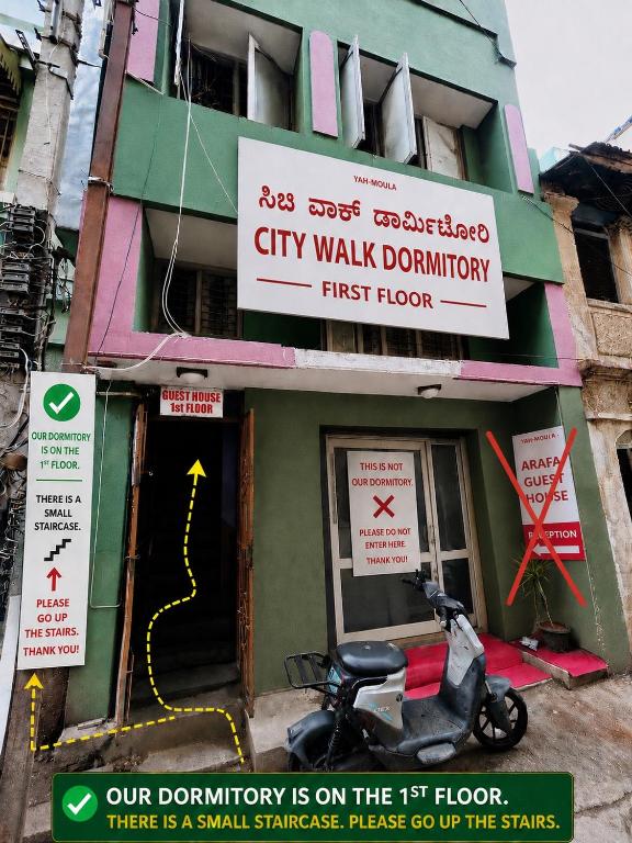 a scooter parked outside of a city walk dictionary at City walk dormitory in Bangalore