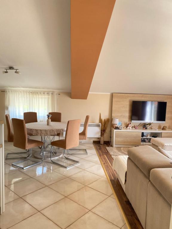 a living room with a table and a couch at Purple Haze Apartments in Tivat