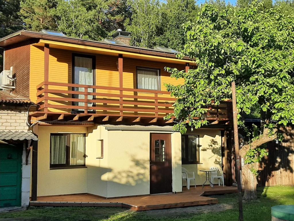 a house with a porch and a deck at Lerihouse in Saulkrasti