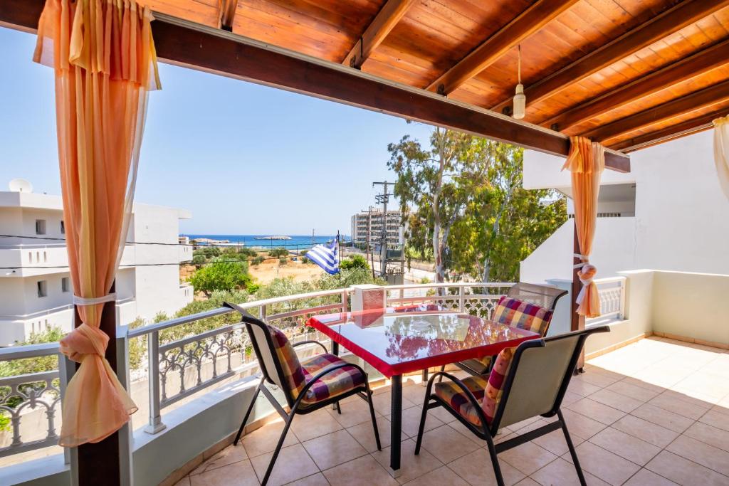 a balcony with a table and chairs and a view at Spacious 2BR Apartment with Balconies in Karpathos
