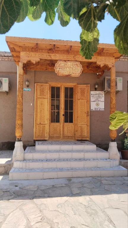 a entrance to a building with a wooden door at Гостевой дом Hotel Allanazar Ota in Khiva