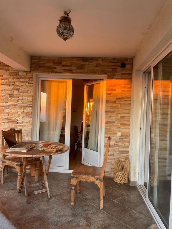 a patio with a table and chairs and a brick wall at A house with the view in Bar