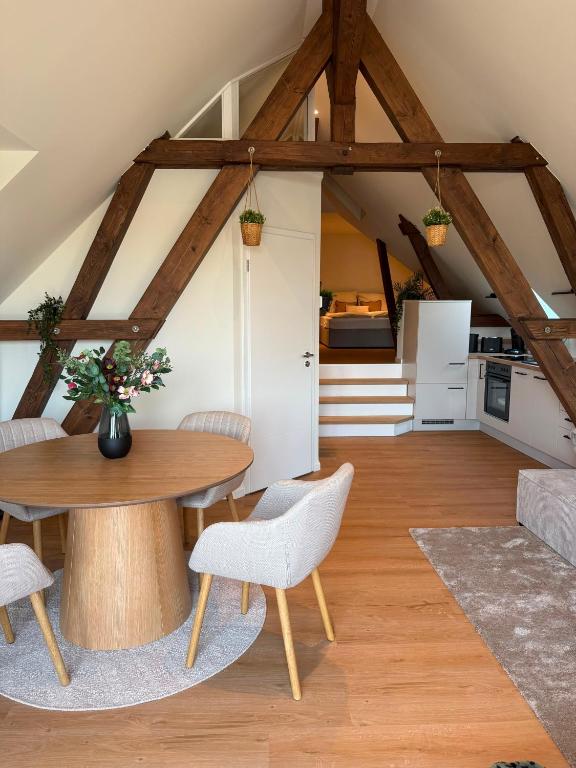 a living room with a wooden table and chairs at Loft Günni mit Whirlpool in Wietzendorf