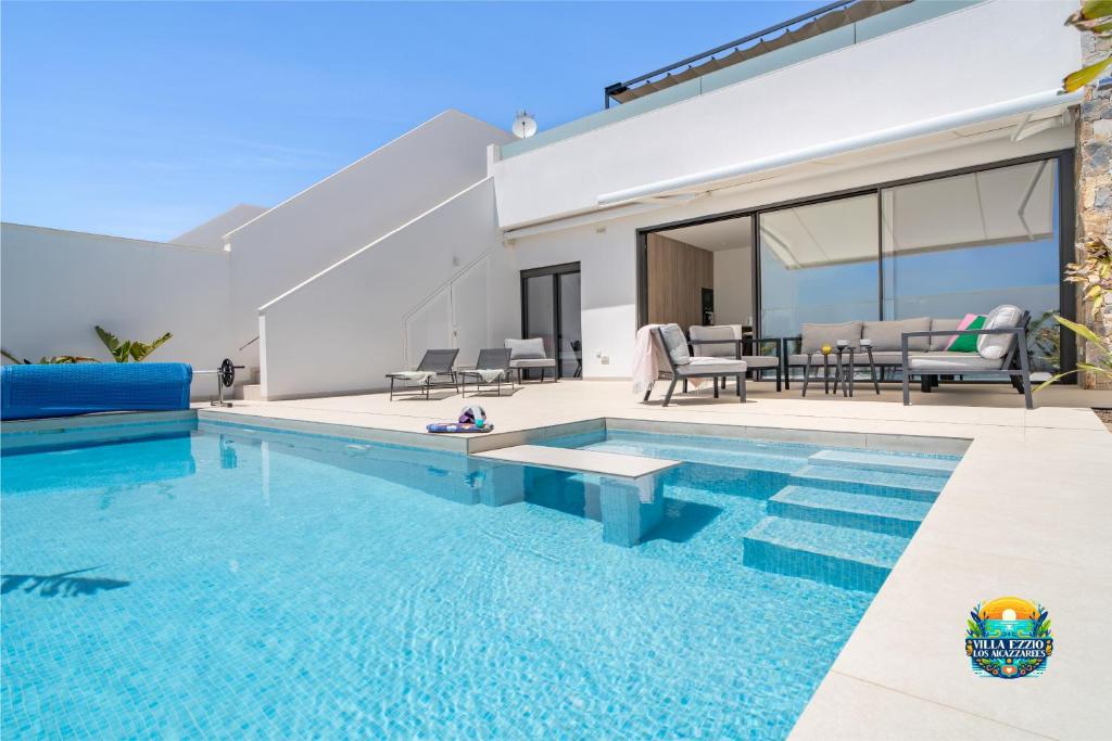 a house with a swimming pool and a patio at Villa Ezzio Los Alcazares in Los Alcázares