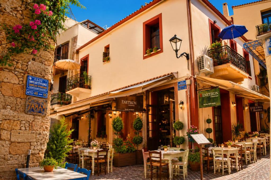 a street with tables and chairs in front of a building at Enetiko Rooms in Chania