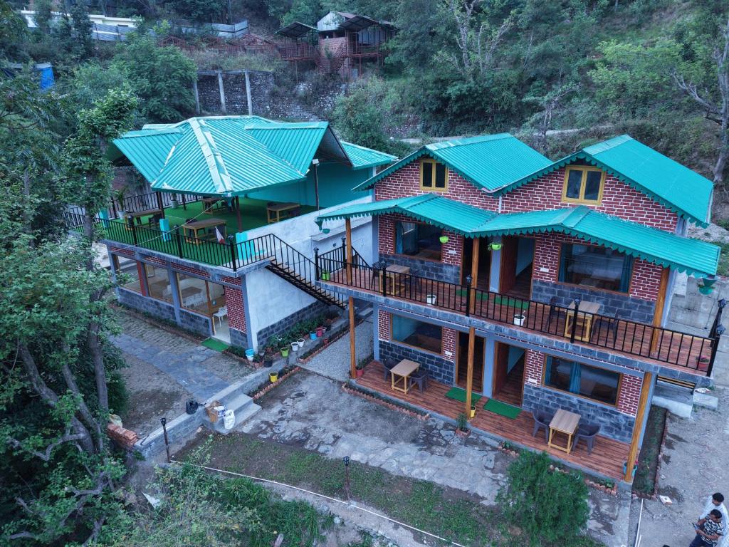 an overhead view of a house with green roof at Jungle Valley Camp & Resort in Nainital