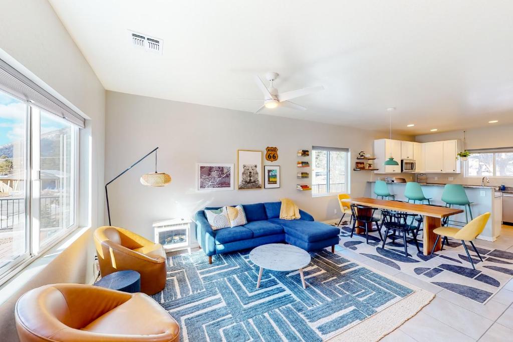 a living room with a blue couch and a table at The Pine House in Flagstaff