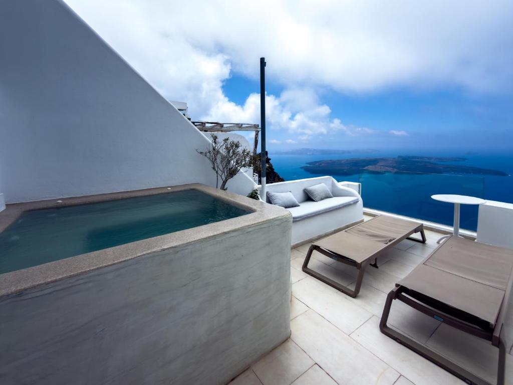 a swimming pool on the roof of a house at Diamond on the cliff Hotel&Suites Imerovigli in Imerovigli