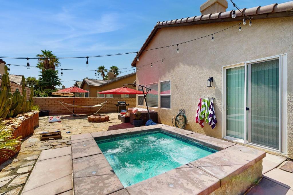 a swimming pool in the backyard of a house at Tranquil Desert Sanctuary in Indio