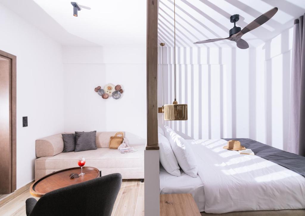 a living room with a bed and a couch at Elea Terra Hotel in Matala