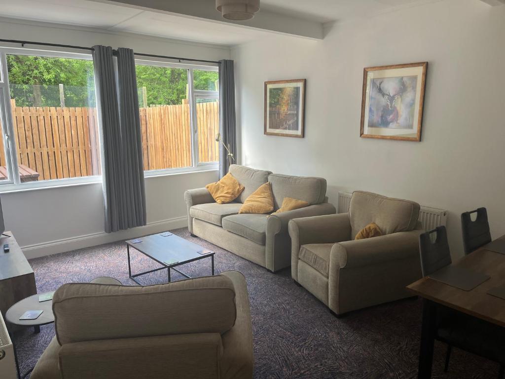 a living room with two couches and a table at Beamish Lodge in Stanley