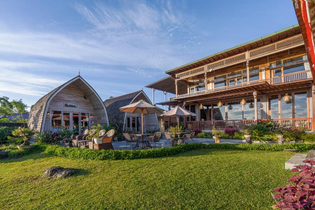 an exterior view of a house with a yard at Mountain Healing Villa by Nagisa Bali in Baturiti