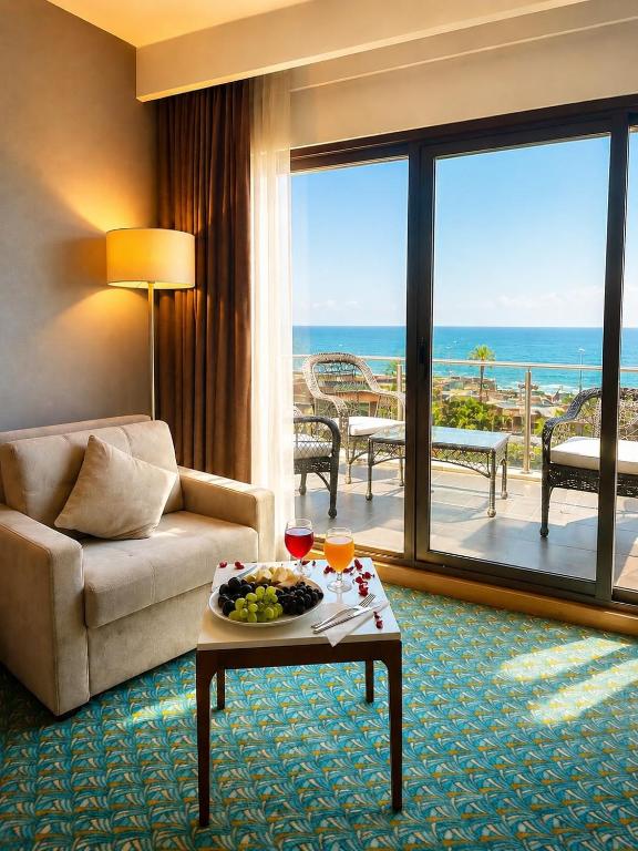 a living room with a couch and a table with food on it at Blue Sea Hotel in Trabzon