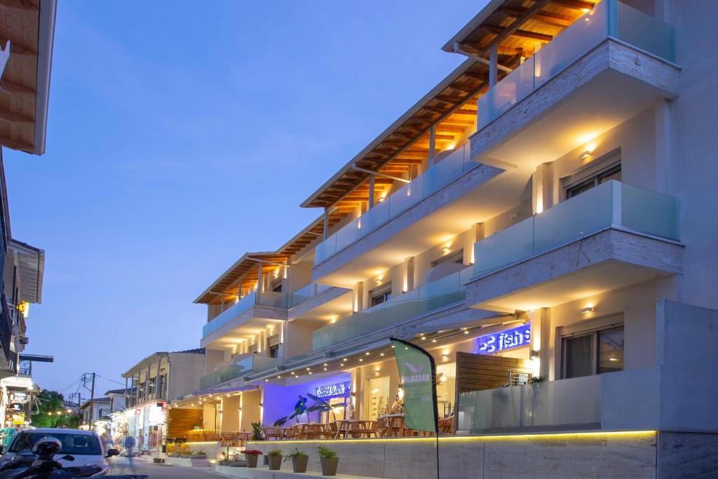 a building with a sign on the side of it at Grand TheoNi Boutique Hotel & Spa in Vasiliki
