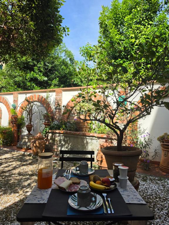 a table with food and drinks on a patio at B&B Firenze 400 in Florence