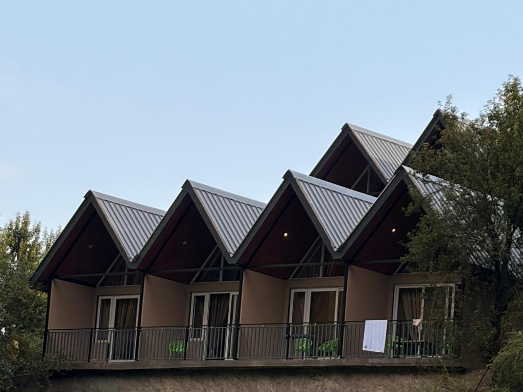 a house with a metal roof at Pahadi Sukoon - A frame Cottages in Dharamshala