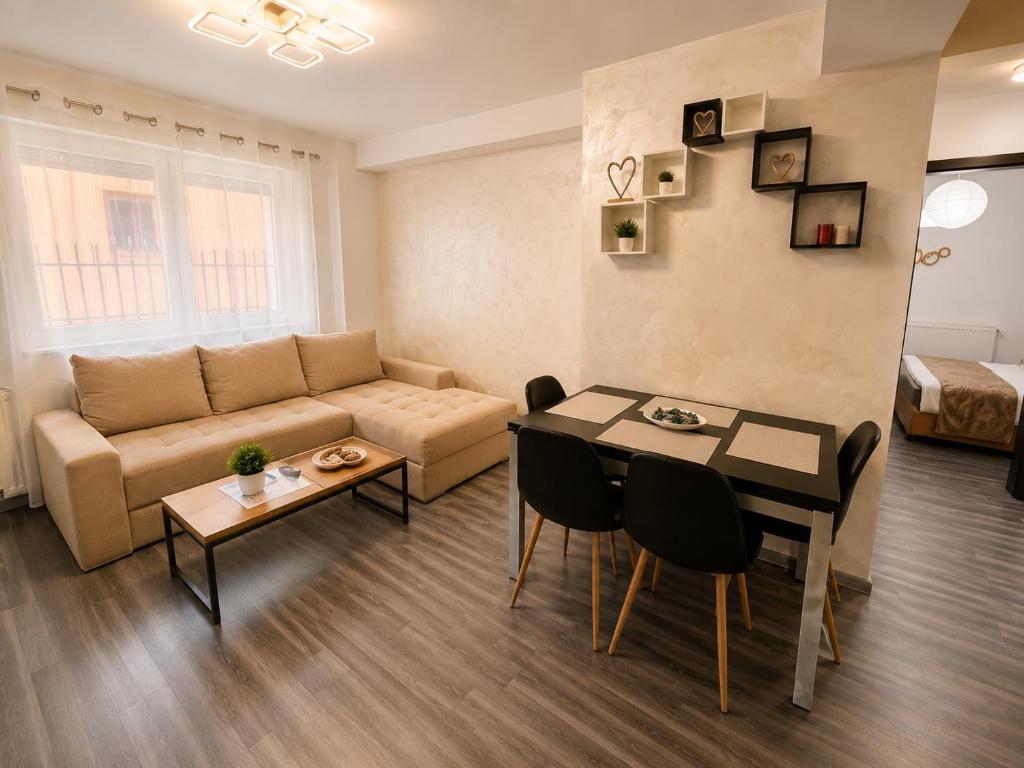a living room with a couch and a table at ARKADIA 2 BR APARTMENTs in Bucharest