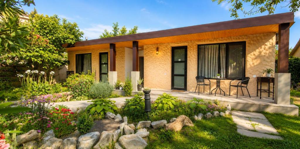 a house with a garden in front of it at GuestRoom KOKO in Mtskheta