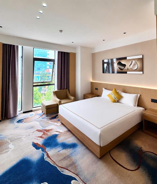 a bedroom with a large bed and a large rug at Kim Thành Hotel in Bắc Ninh