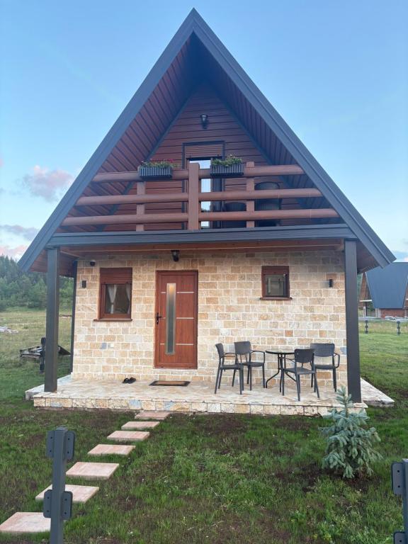 a small house with a picnic table in front of it at Zabljak villa VAM in Žabljak