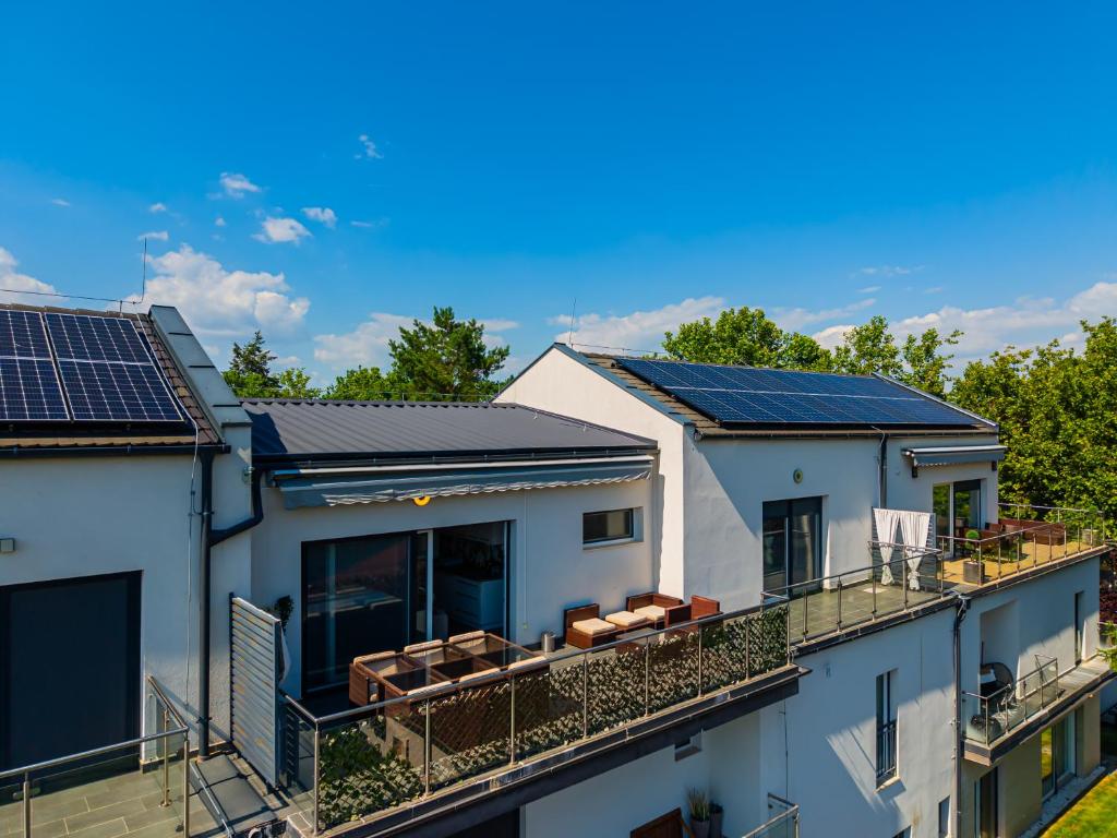 a row of houses with solar panels on their roofs at AH-Premium Rooftop Apartman in Zamárdi