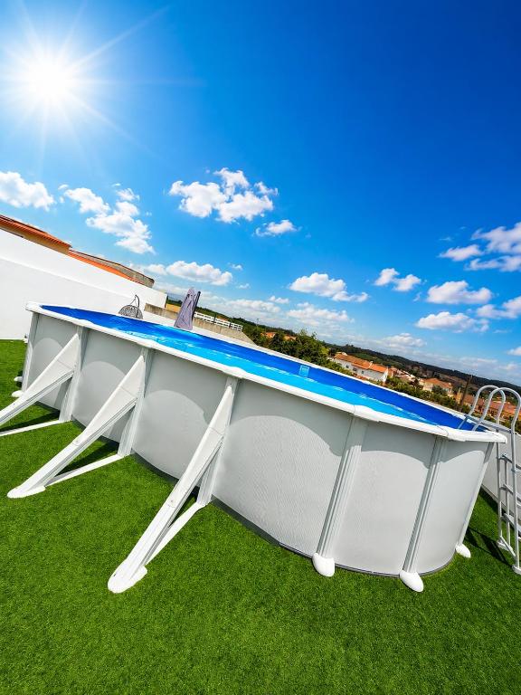 a large white ping pong table on the grass at Montejunto Escape in Cadaval