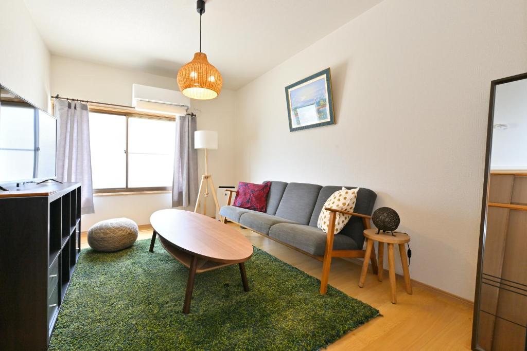 a living room with a couch and a table at Shion 潮音 in Sakaide