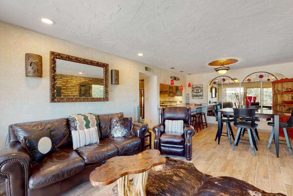 a living room with a leather couch and a table at Tranquil Trail #8 in Carefree