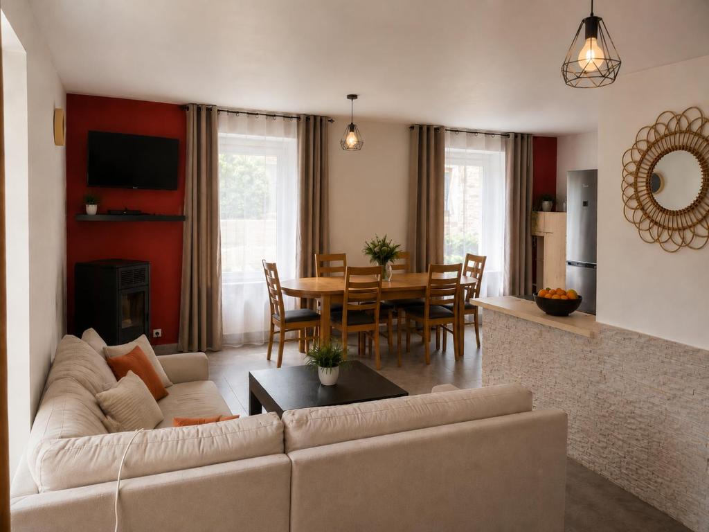 a living room with a couch and a table at Résidence d'Emilie in Luxeuil-les-Bains