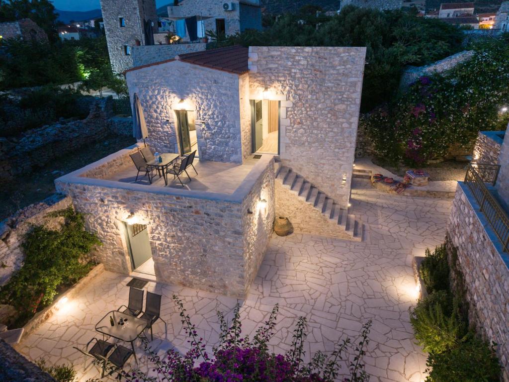 a house with a patio with chairs and lights at Mainotti's house in Areopoli