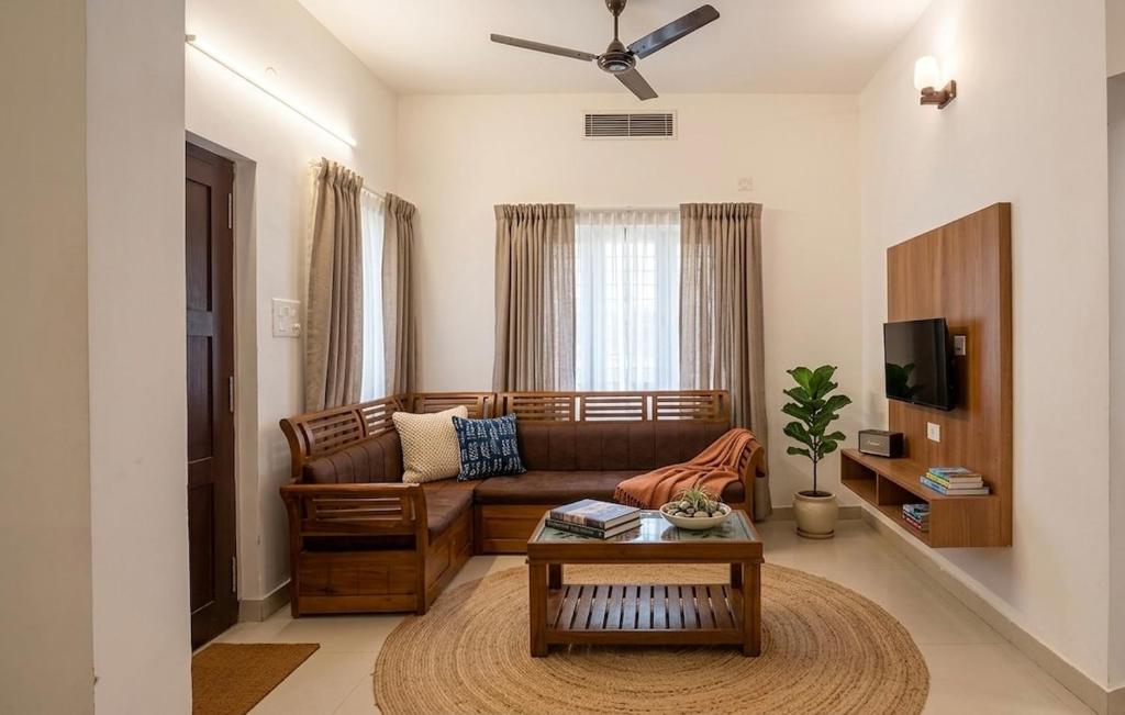 a living room with a couch and a coffee table at Urban Escape in Cochin