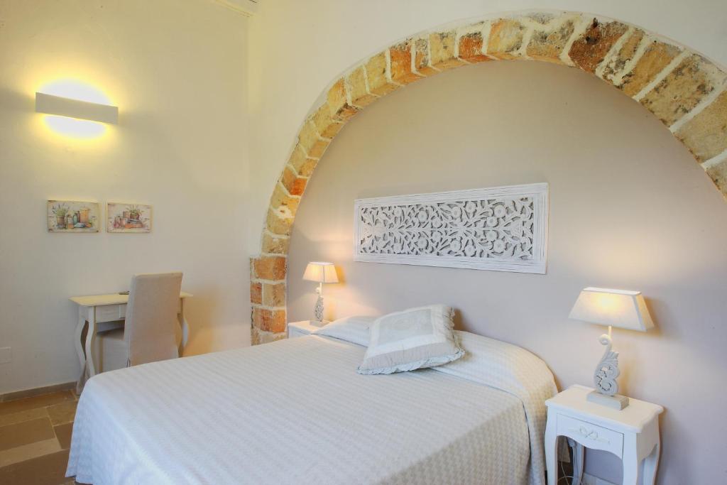 Cama o camas de una habitación en Masseria La Tofala benessere & SPA