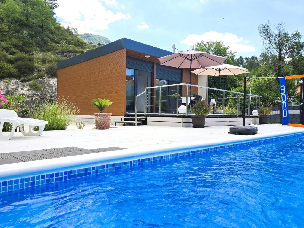 a house with a swimming pool in front of a house at Villa Krivokapic in Trebinje