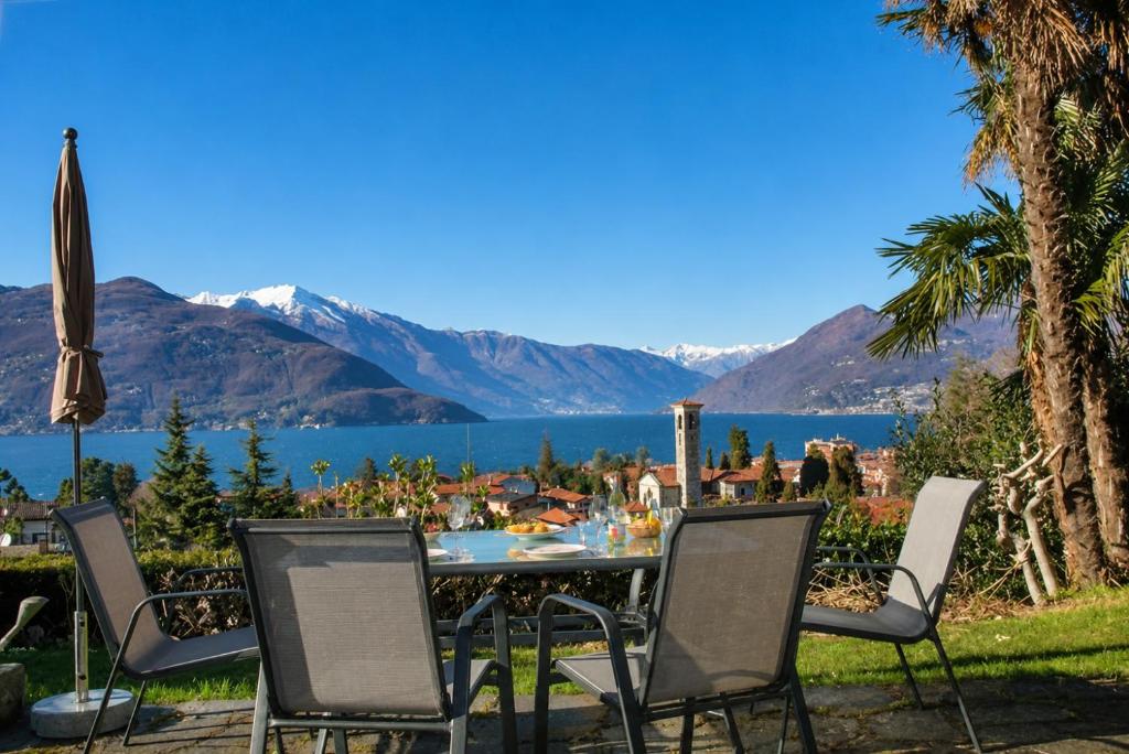 a table and chairs with a view of a lake at Sogno dOro in Germignaga