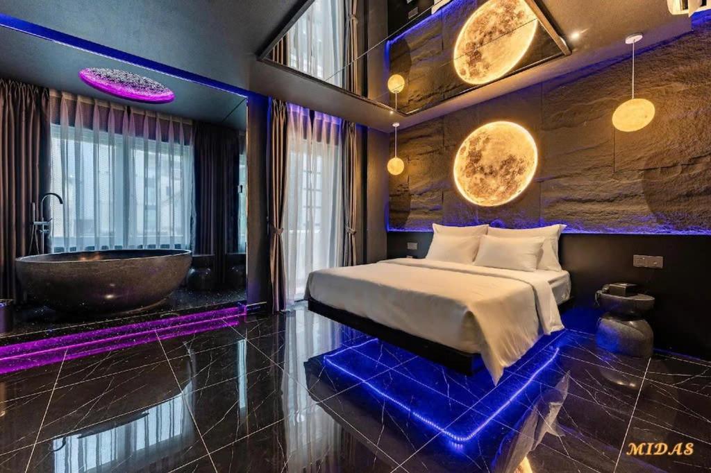 a bedroom with a bed and a tub and a sink at Midas Hotel 2 in Ho Chi Minh City