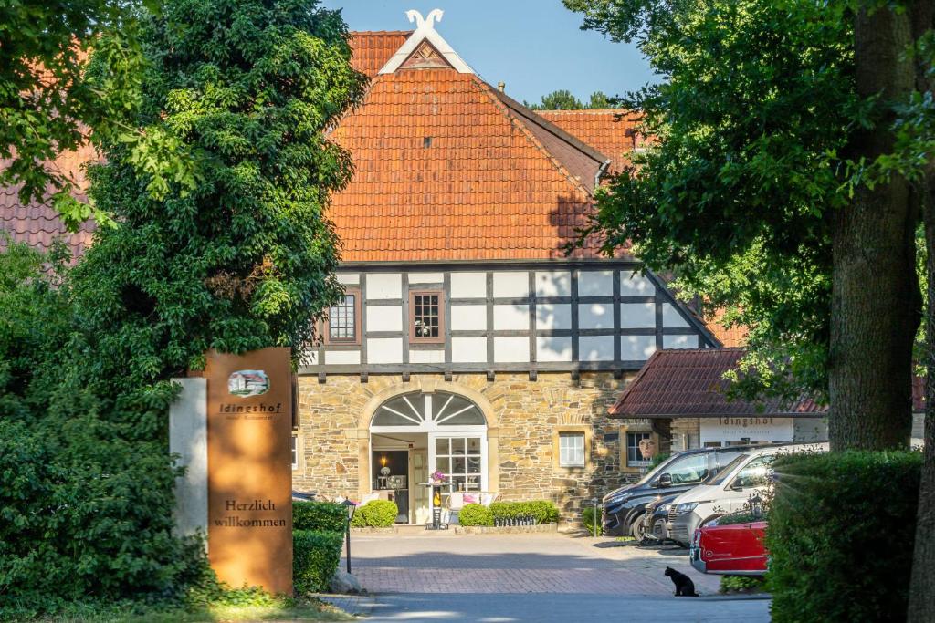 a building with a sign in front of it at IDINGSHOF Hotel & Restaurant in Bramsche