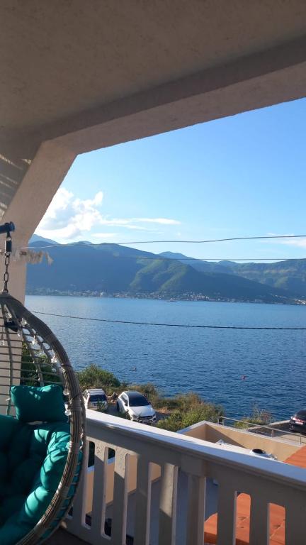 a balcony with a view of a body of water at ApartmaniNET in Krašići
