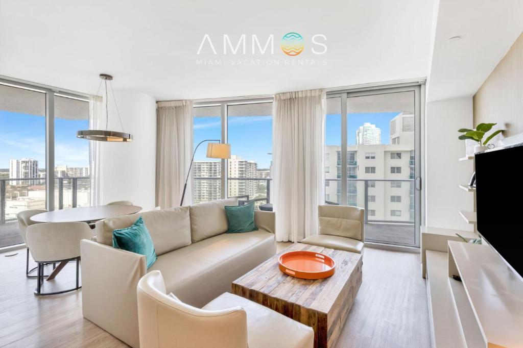 a living room with a couch and a table at Ocean View Balcony with Pool Gym Access in Hallandale Beach