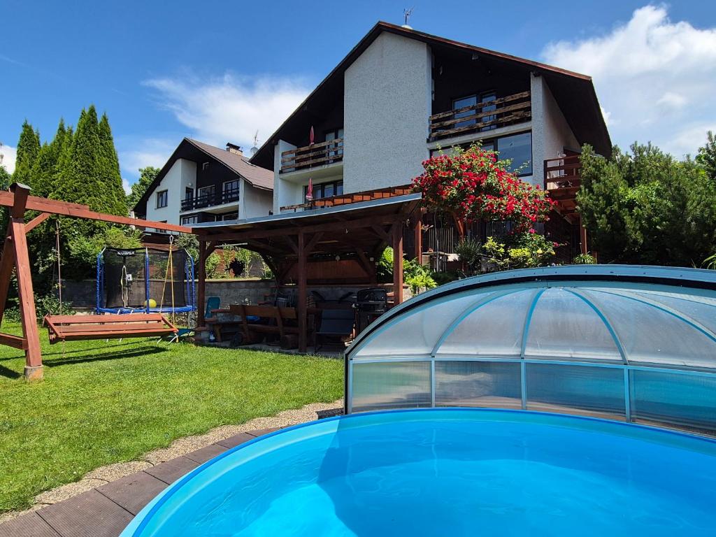 a house with a swimming pool in front of a house at Dům Jaroslava in Černý Dŭl
