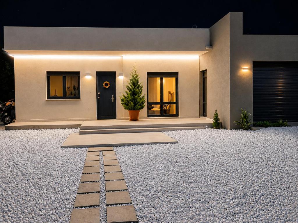 a house with a gravel driveway in front of it at Villa ATLAS relax in Prinos