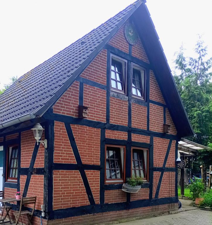 a red brick house with windows and a roof at The Red House in Celle