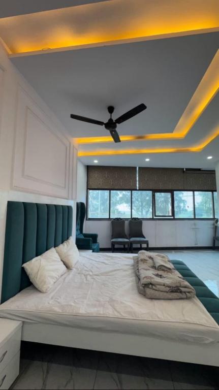 a bedroom with a large bed with a ceiling fan at Hotel River View in Ghaziabad