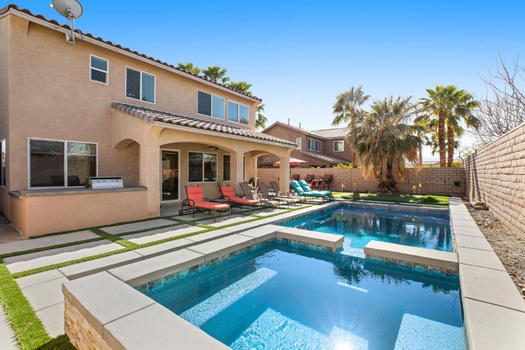 a swimming pool in the backyard of a home at Casa Whimsy in Indio